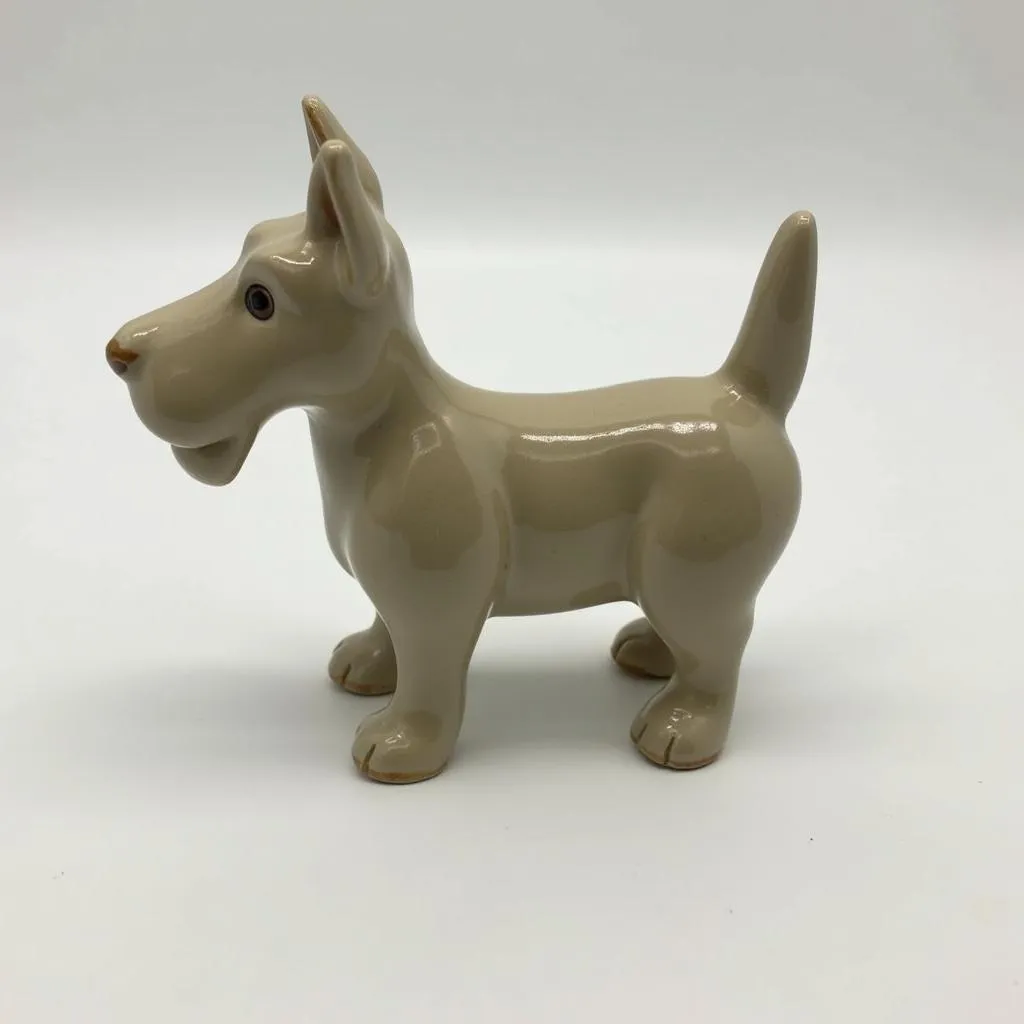 A ceramic Scottie dog figurine sitting on a shelf