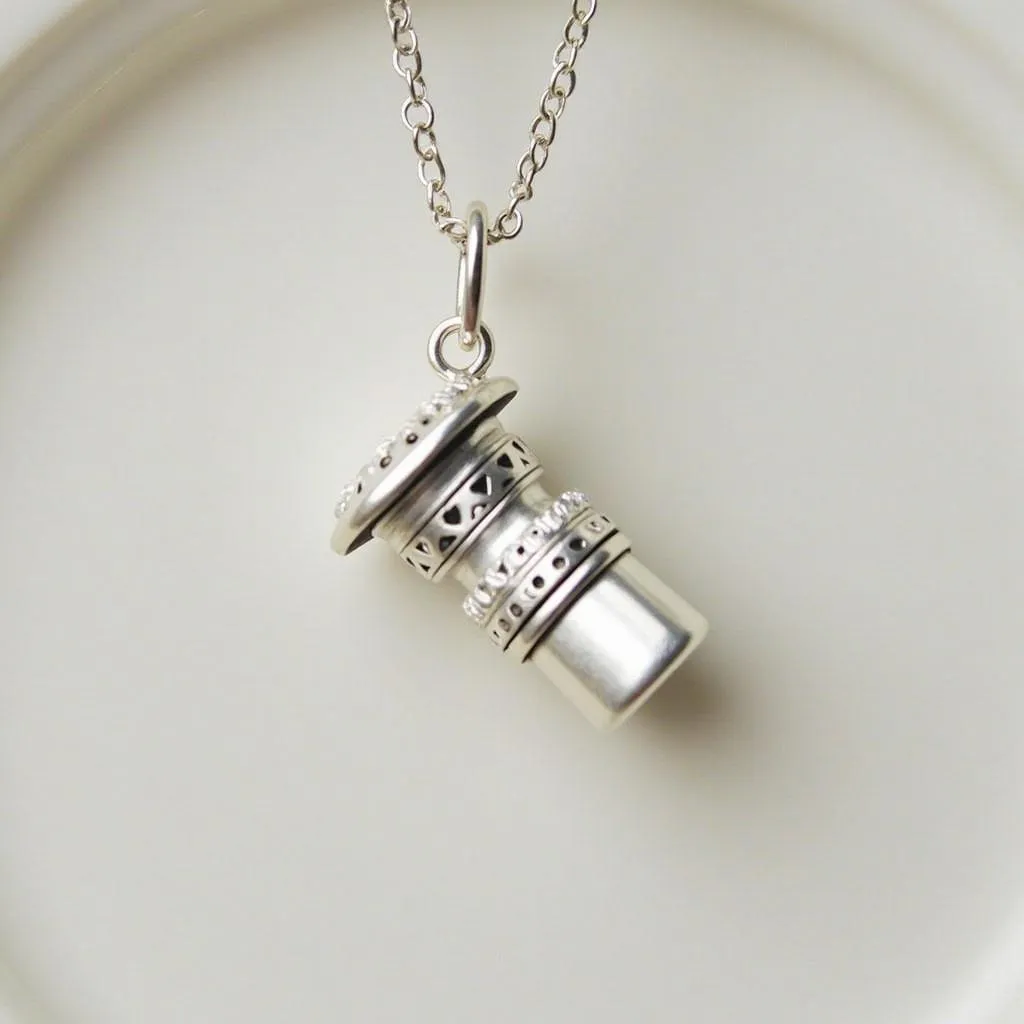 Close-up view of an urn necklace for dog ashes